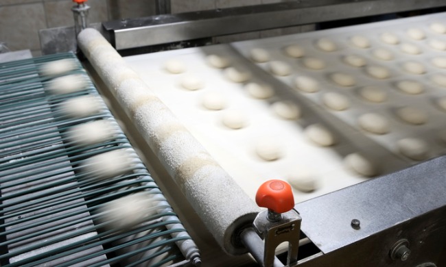 Young worker caught in dough machine, suffers critical injury