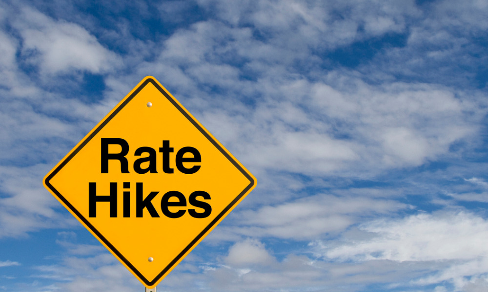 Another central bank holds rates but warns hikes still possible