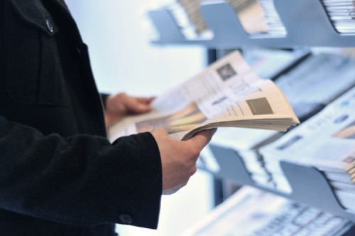 Two QBE Australia leaders sell street papers for a cause