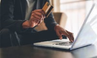 Americans are reducing spending, dipping into savings: Wells Fargo