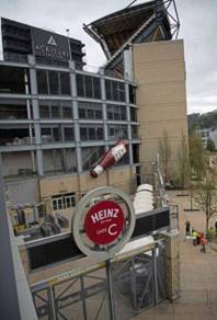 One of the ketchup bottles was reinstalled above Gate C outside the stadium.