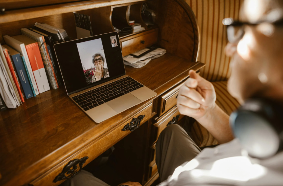 a man and a woman on a video call, a visual representation of Canadian spousal sponsorship