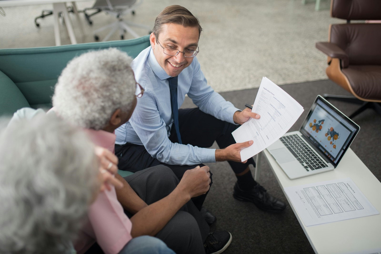 insurance agent explaining insurance policy to elders
