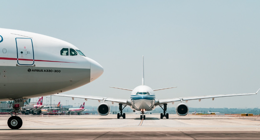commercial planes are on the tarmac, waiting to take off
