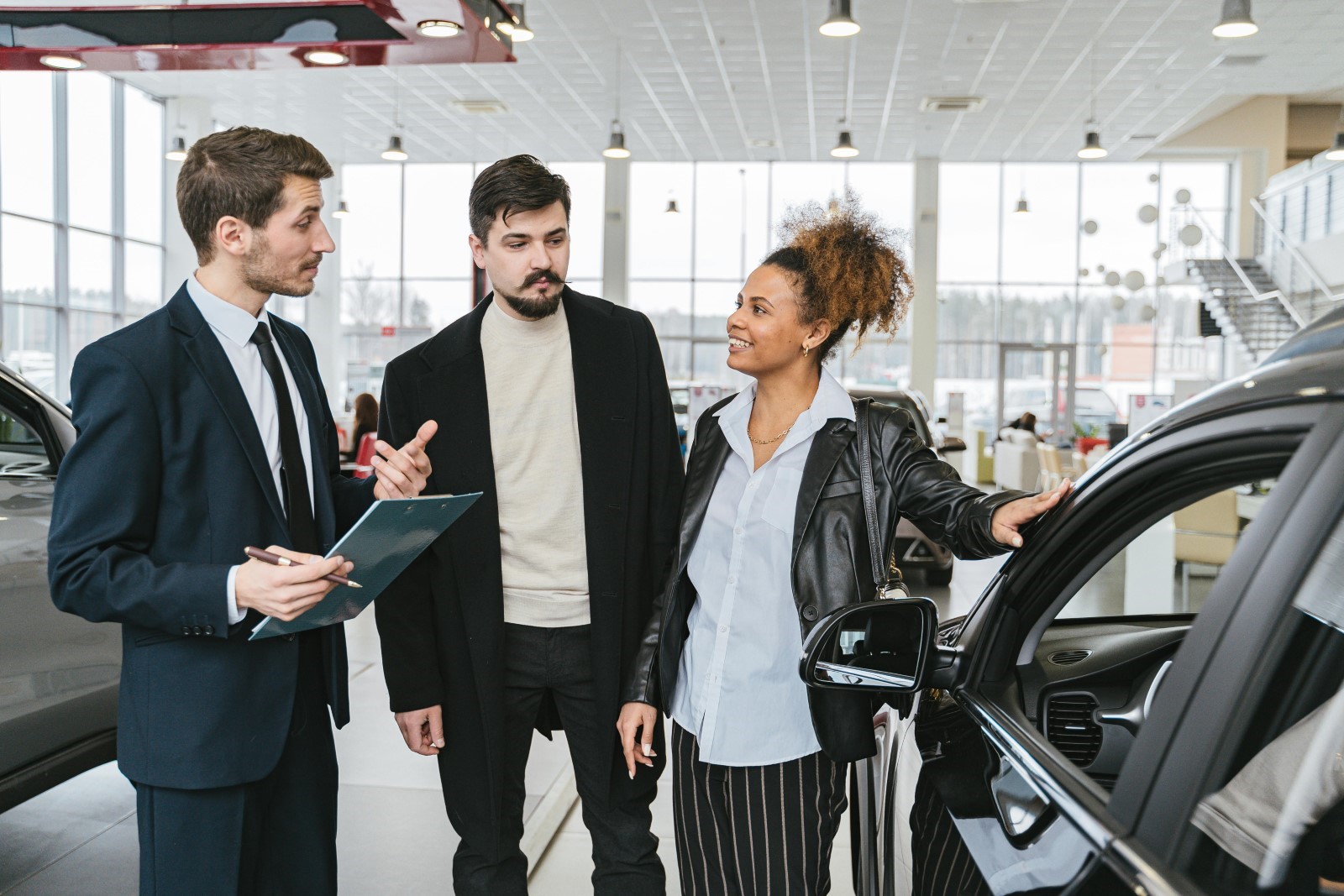 Couple having insurance explained to them while at a car dealership