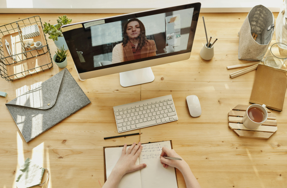 a woman on a computer screen is being interviewed by a recruiter for an agency that handles remote jobs