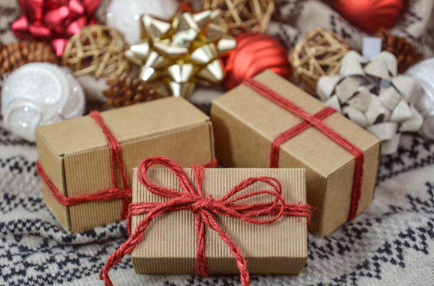 small boxes of presents with Christmas ornaments in the background to signify Boxing Day, a public holiday in Australia