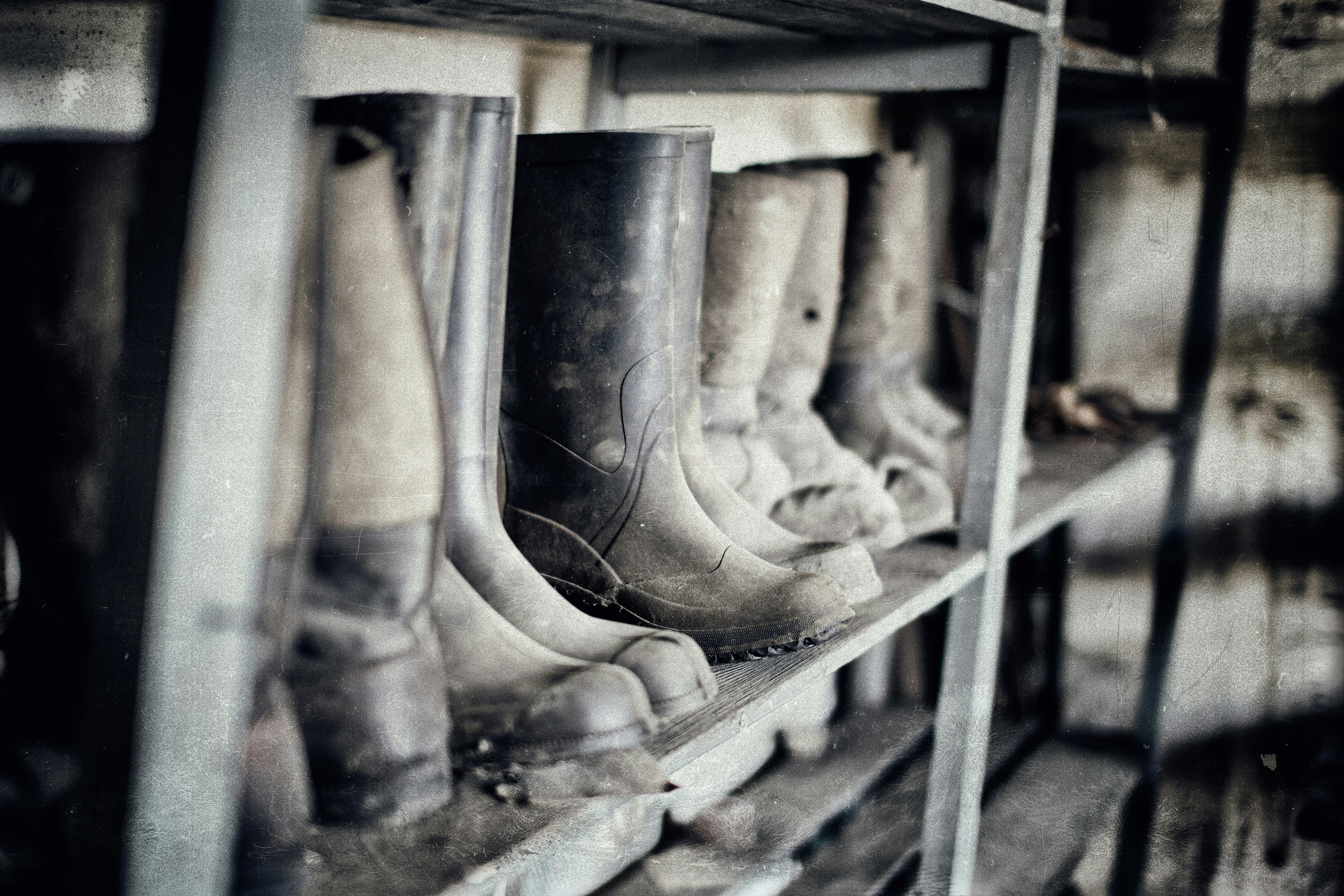  row of dirty safety boots on a shelf