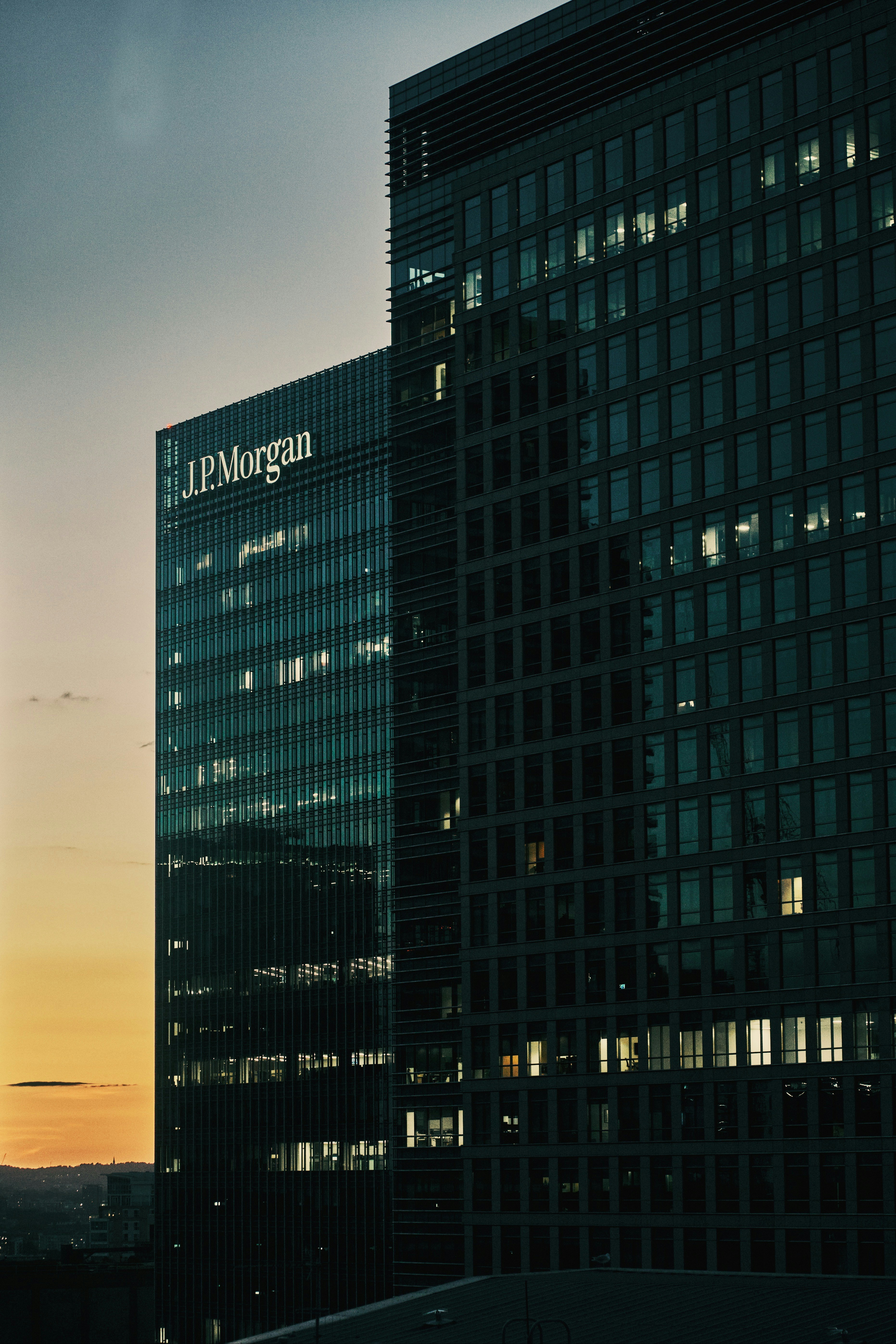 building facade of JPMorgan, one of America’s biggest banks, set against an orange sky