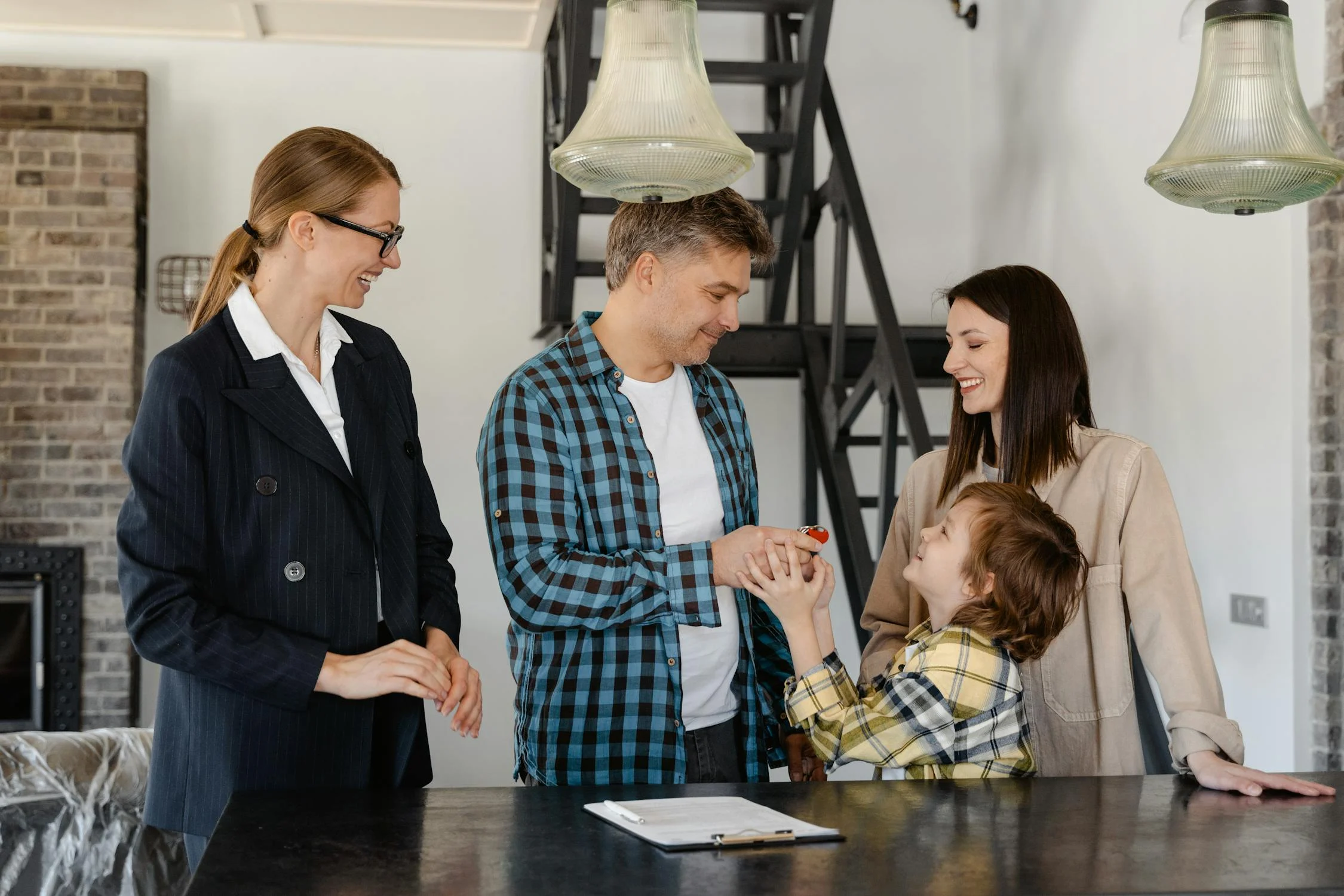  a real estate agent speaking with first time buyers about their home purchase