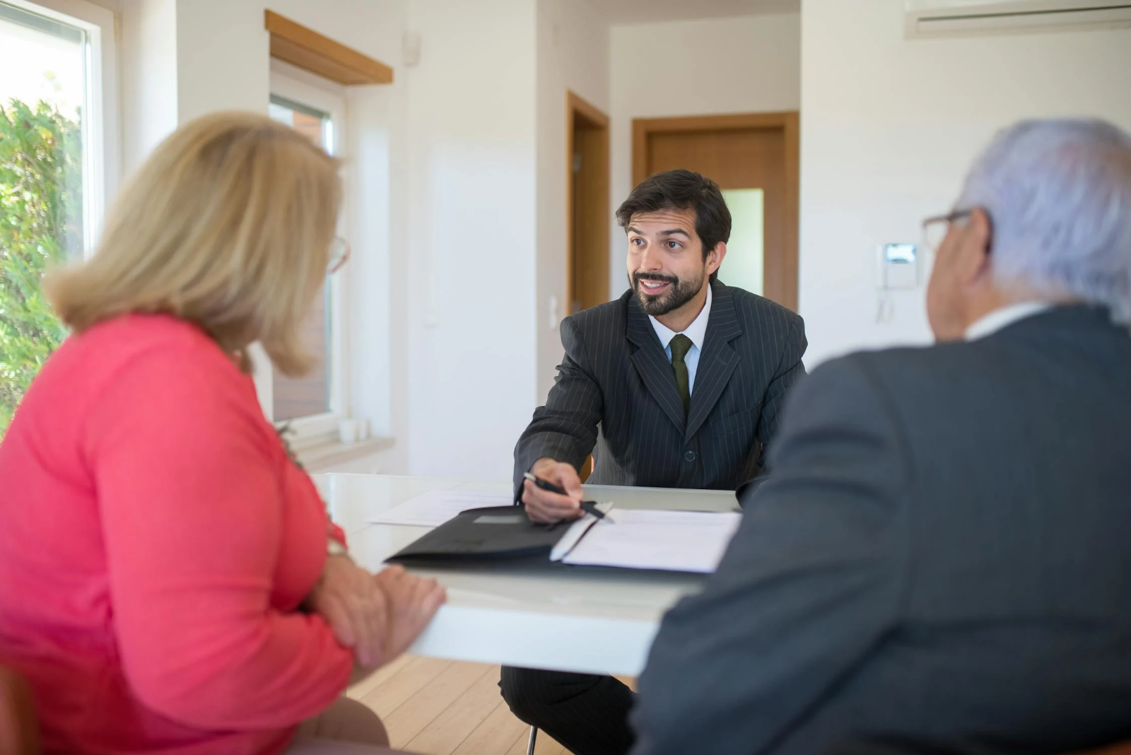 a newly licensed credit representative talks to his clients about a mortgage solution that fits their budget and circumstances