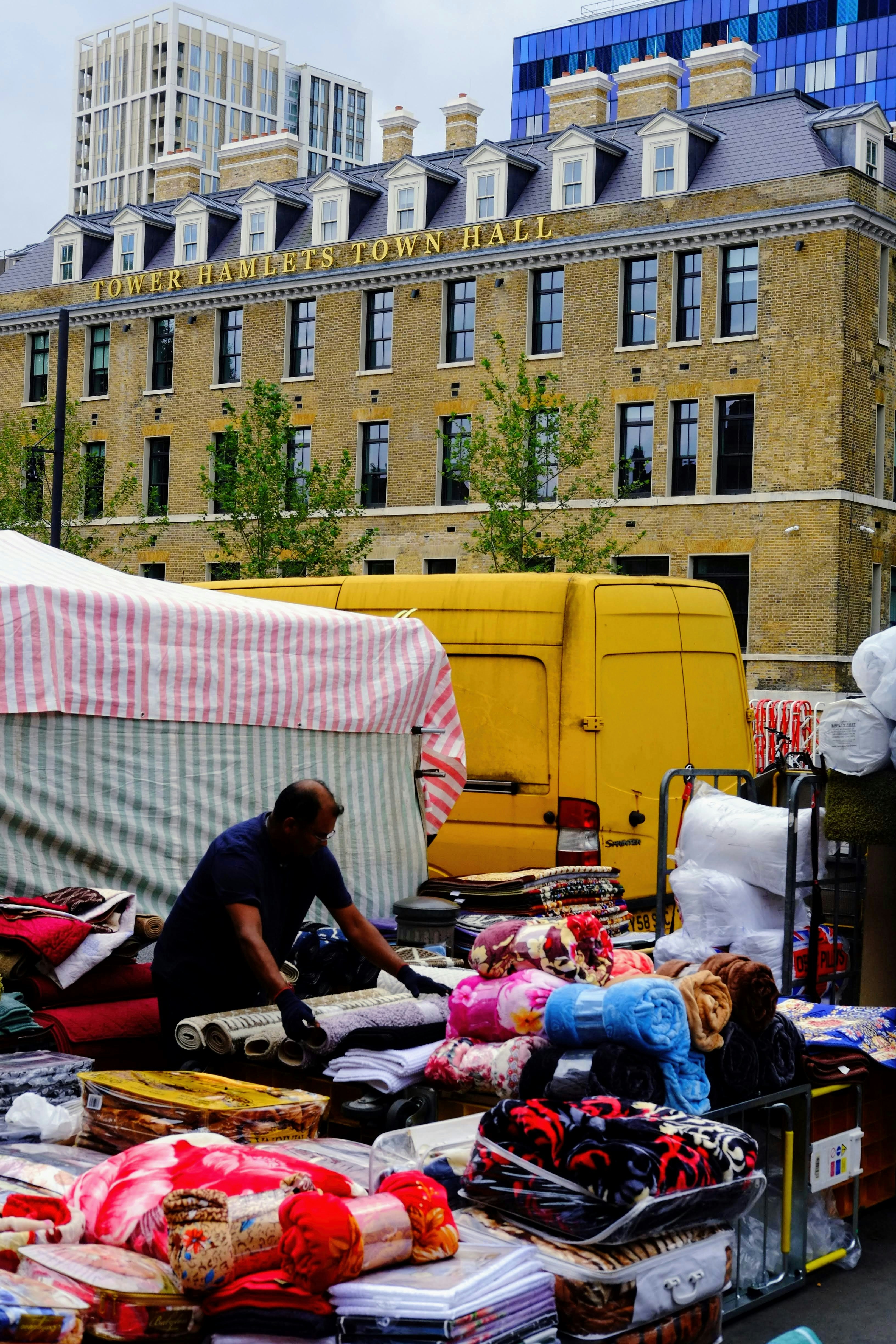 a vendor selling goods in front of Tower Hamlets Town Hall