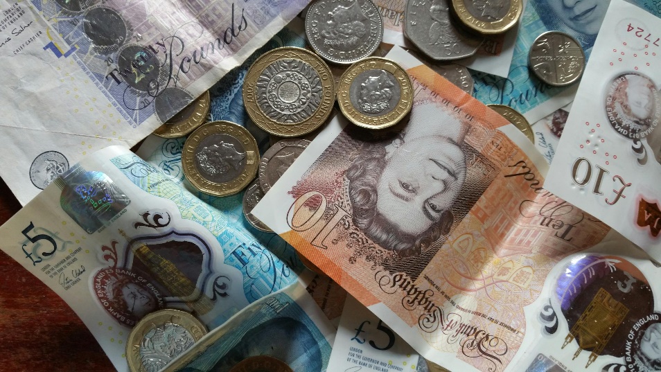 a close-up of British pound sterling notes and coins