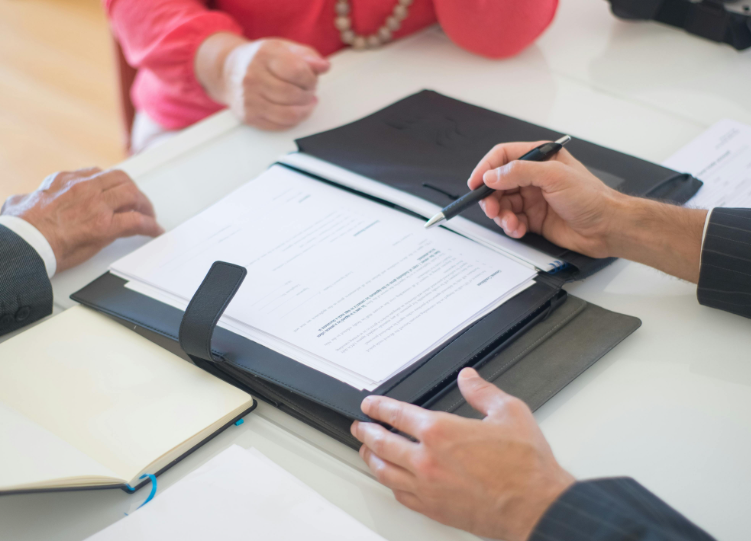 a mortgage broker discusses the mortgage terms to his client with a representative from Paragon for intermediaries